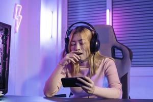 Asian woman gamer play computer video game concept. photo