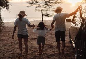 Family with Car travel driving road trip summer vacation in car in the sunset, Dad, mom and daughter happy traveling enjoy holidays and relaxation together get the atmosphere and go to destination photo