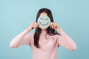 woman holding happy smile face on paper cut, user giving good feedback rating, think positive , customer review, assessment, of mental health day, Compliment Day, satisfaction concept. photo