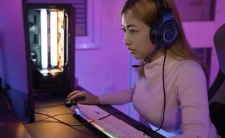 Asian woman gamer play computer video game concept. photo