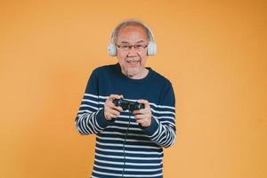 Asian Senior older man family having fun enjoying play video game funny video. Happiness lifestyle on retirement concepts. photo