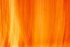 Bright orange background with small vertical waves and highlights. Abstract background for design. photo