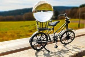 a small decorative bicycle with a glass ball with neon style photo