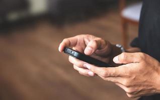 Close-up view of male hand using a smartphone. concept of social media and technology network photo