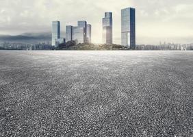 Apocalyptic atmosphere unmanned asphalt pavement plaza with panoramic city skyline background photo