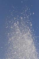 splash of water in fountain against blue sky photo