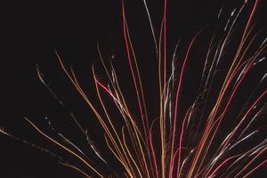 color tracks from holiday fireworks in night sky photo