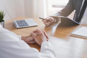 Asian young manager, employer man interview with person, have question about resume and listen to candidate answer, conversation together at office. Recruitment employee job concept. photo