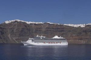 view of cruise ship in caldera of Santorini island photo