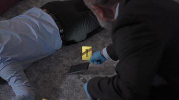 Criminal investigation police are trying to solve the case in his head by examining the evidence at the crime scene. video