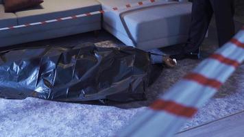 Policeman looking at body bag at crime scene. In the criminal area, the police look at the corpse in the bag and examine its surroundings. video