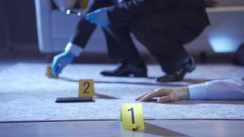 Policeman in suit carefully examines evidence with gloves and tweezers at crime scene. Police man conducting a murder investigation examines evidence at the crime scene. video
