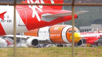 PHUKET, THAILAND - DECEMBER 1, 2016  AirAsia Airbus 320 HS-ABI and NOK Air Boeing 737 taxiing before departure from Phuket International airport video