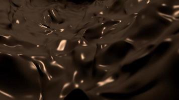 Flowing stream of dark, silky melted chocolate motion background. video