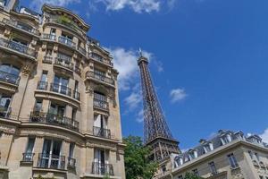 Eiffel tower behind buildings in Paris photo