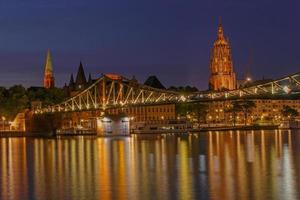 view on footbridge and old center of Frankfurt am Main at night photo