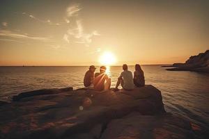 Group of five happy people sits on background of empty sunset beach. Travel or sea vacations concept photo