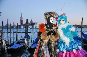 Unidentified people wearing carnival masks at the Venice Carnival in Venice, Italy, circa February 2022 photo