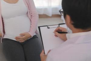 Asian young pregnant women have psychologist consultation at hospital or clinic,from panic and worried pregnancy condition, expecting family.Which must be treated with therapy before the baby is born. photo