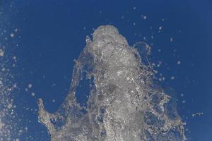 splash of water in fountain against blue sky photo