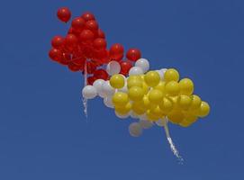 bunch of air balloons flying in a blue sky photo