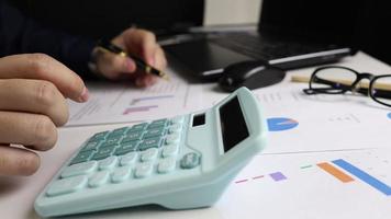 Close-up view of male hand using calculator to calculate income for family accounting video