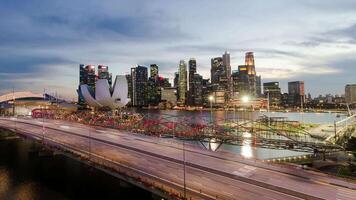 timelapse landscape mega city view of singapore downtown financial district area with many highrise office skyscraper building and some traffic on highway in sunset time video