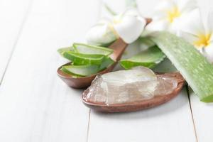 Aloe vera in wood spoon on old white wood background photo