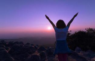 Happy child on mountain on sunset background. photo