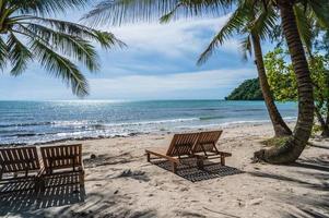 Wooden chair beside the beach with beautiful idyllic seascape view on kohkood island.Koh Kood, also known as Ko Kut, is an island in the Gulf of Thailand photo