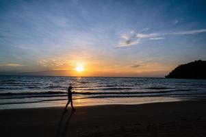 Silhouette people with Beautiful idyllic seascape sunset view on kohkood island in low season travel.Koh Kood, also known as Ko Kut, is an island in the Gulf of Thailand photo