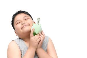 Obese boy holding piggy bank on hand isolated