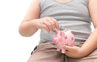 hand child put dollar banknotes into piggy bank photo