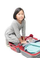 cute asian girl packing suitcases preparing for travel trip isolated photo