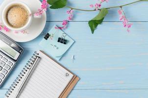 Blank note book and hot coffee with calculator photo