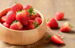 fresh Red berry strawberries in wood bowl photo