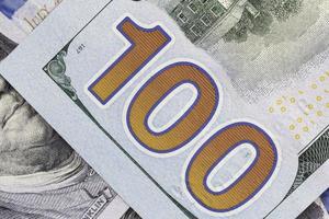 close up of number 100 on one hundred dollars banknote photo