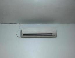 White AC Air conditioning for cooling temperature in the room indoor isolated photo on white walls and ceiling.