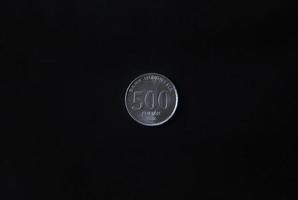 Indonesian single one 500 silver coin rupiah currency. Economy market simple concept photo isolated on black background.