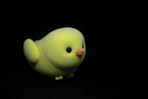 Chicken toy pet cute miniature kids toy isolated on dark black background. photo