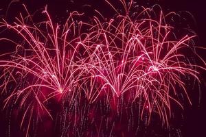 red holiday fireworks in night sky photo