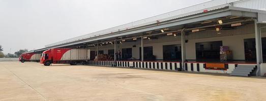 Ratchaburi, Thailand-February 27, 2023 Cargo or Warehouse for storage and transport parcel for shipping by mail and copy space. Building for distribution, Import and Export goods by red container car photo