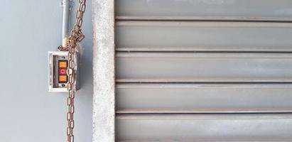 Red and orange button with chain for open and closed steel shutter door in cargo terminal. Object, Technology and Background concept photo