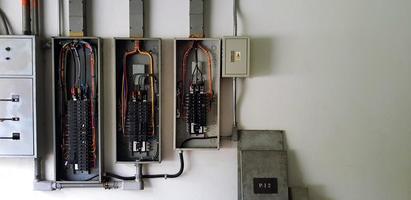 Many circuit breaker for distribute electricity in building on white wall with right copy space in main electrical room photo