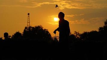 silhouettes Man is holding the shuttlecock and the badminton racket photo