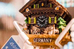Germany souvenir refrigerator magnet. Refrigerator magnets are popular souvenir and collectible objects. Traditional German clock with country title. photo