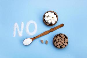 word no next to a wooden bowl filled with different types of sugar photo