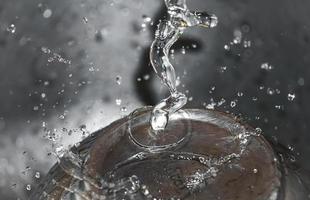 Water drop splashing macro with waves photo