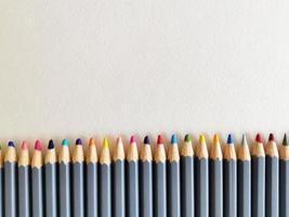 Colored pencils background. Color pencils on white background. photo