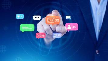 People using social media and digital online marketing concepts with icons such as notifications, messages, comments on the screen. photo